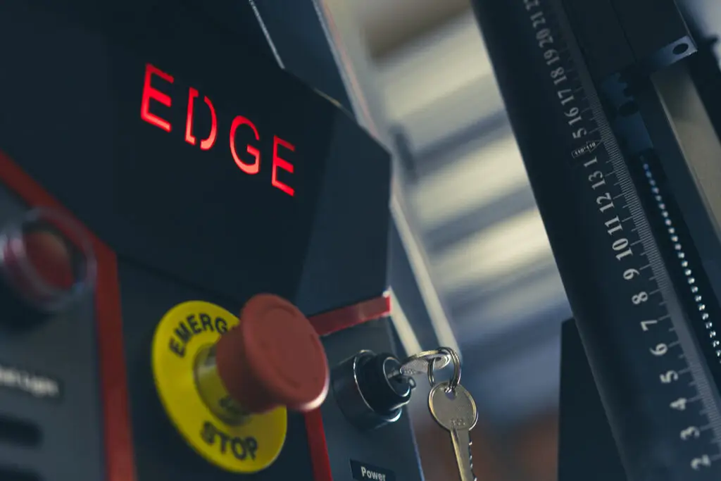 Edge fiber laser machine in a workshop environment, showcasing its precision build and modern industrial design.