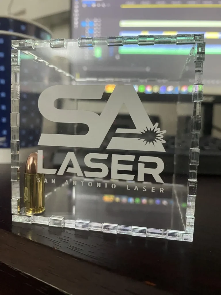 Image of the SA Laser logo engraved on an acrylic cube.