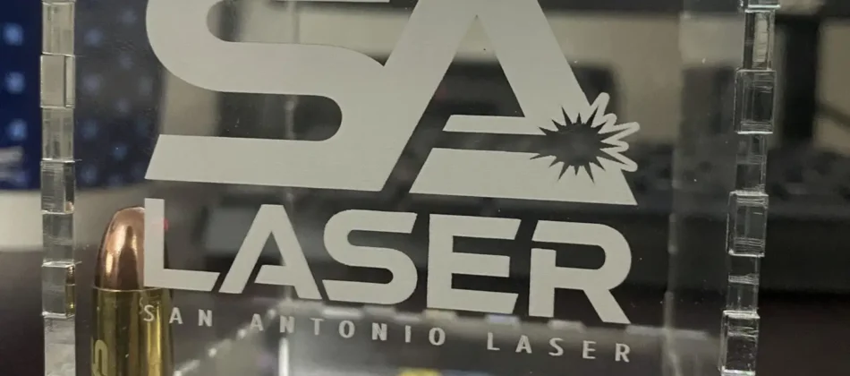 Image of the SA Laser logo engraved on an acrylic cube.
